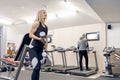 Young beautiful blond woman doing strength exercises with dumbbells in gym. Sport, fitness, bodybuilding, training, workout Royalty Free Stock Photo