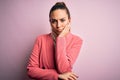 Young beautiful blonde businesswoman with blue eyes wearing elegant pink jacket thinking looking tired and bored with depression Royalty Free Stock Photo