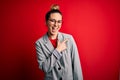 Young beautiful blonde businesswoman with blue eyes wearing glasses and jacket cheerful with a smile of face pointing with hand Royalty Free Stock Photo