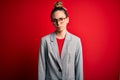 Young beautiful blonde businesswoman with blue eyes wearing glasses and jacket skeptic and nervous, frowning upset because of Royalty Free Stock Photo