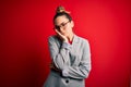 Young beautiful blonde businesswoman with blue eyes wearing glasses and jacket thinking looking tired and bored with depression Royalty Free Stock Photo