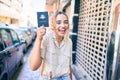 Young beautiful blonde caucasian woman smiling happy outdoors on a sunny day showing Australia passport Royalty Free Stock Photo