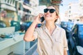 Young beautiful blonde caucasian woman smiling happy outdoors on a sunny day using smartphone Royalty Free Stock Photo