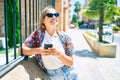 Young beautiful blonde caucasian woman smiling happy outdoors on a sunny day using smartphone Royalty Free Stock Photo