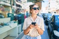 Young beautiful blonde caucasian woman smiling happy outdoors on a sunny day using smartphone Royalty Free Stock Photo