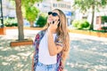 Young beautiful blonde caucasian woman smiling happy outdoors on a sunny day using smartphone Royalty Free Stock Photo