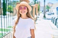 Young beautiful blonde caucasian woman smiling happy outdoors on a sunny day wearing summer hat and pink sunglasses Royalty Free Stock Photo