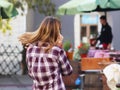 Young beautiful blonde girl communicates on a smartphone in the street of the old city. Gadgets in everyday communication. New tec