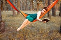 Young blonde girl in hammock reading book. Pretty woman leisure lifestyle at nature ountdoor. Female relax in forest. Royalty Free Stock Photo