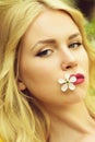 Young girl holds in the mouth a white cherry flower Royalty Free Stock Photo