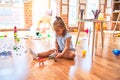 Young beautiful blonde girl kid enjoying play school with toys at kindergarten, smiling happy playing with dinosaurs toys at home