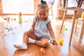 Young beautiful blonde girl kid enjoying play school with toys at kindergarten, smiling happy playing with dinosaurs toys at home