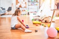 Young beautiful blonde girl kid enjoying play school with toys at kindergarten, smiling happy playing with inteligence toys at