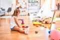 Young beautiful blonde girl kid enjoying play school with toys at kindergarten, smiling happy playing with inteligence toys at