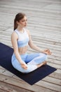 Young beautiful blonde girl practicing yoga outside. Royalty Free Stock Photo