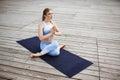 Young beautiful blonde girl practicing yoga outside. Royalty Free Stock Photo