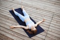 Young beautiful blonde girl practicing yoga outside. Royalty Free Stock Photo