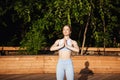 Young beautiful blonde girl practicing yoga outside at sunrise. Royalty Free Stock Photo