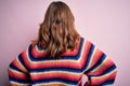 Young beautiful blonde girl wearing glasses and casual sweater over pink isolated background standing backwards looking away with Royalty Free Stock Photo