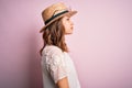 Young beautiful blonde girl wearing summer hat over pink isolated background looking to side, relax profile pose with natural face Royalty Free Stock Photo