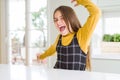 Young beautiful blonde kid girl wearing casual yellow sweater at home Dancing happy and cheerful, smiling moving casual and Royalty Free Stock Photo