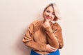 Young beautiful blonde plus size woman wearing casual sweater over isolated white background smiling looking confident at the Royalty Free Stock Photo