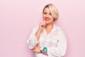 Young beautiful blonde plus size woman wearing elegant shirt over isolated pink background smiling looking confident at the camera Royalty Free Stock Photo