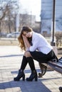 Young beautiful blonde schoolgirl sitting on a bench Royalty Free Stock Photo