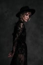 Young beautiful blonde woman in a black hat and dress. Royalty Free Stock Photo