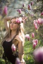 Young beautiful blonde woman in blooming garden. Beautiful natural woman with flowers. Spring girl portrait. Beauty Royalty Free Stock Photo