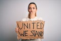 Young beautiful blonde woman with blue eyes asking for united stand holding banner cover mouth with hand shocked with shame for