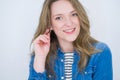 Young beautiful blonde woman with blue eyes smiling at the camera looking happy and confident over isolated white background Royalty Free Stock Photo