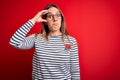 Young beautiful blonde woman with blue eyes wearing glasses standing over red background worried and stressed about a problem with Royalty Free Stock Photo