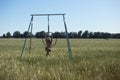 young and beautiful blonde woman doing aerobic exercises on a hoop. On her head a pink scarf against cancer, she is in a wheat Royalty Free Stock Photo