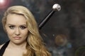 Young beautiful blonde woman or girl with a sword behind the back Royalty Free Stock Photo