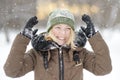 Young beautiful blonde woman having fun in the city park during a heavy snowfall Royalty Free Stock Photo