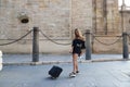 Young and beautiful blonde woman with her suitcase under her arm ready and waiting to start her holiday. Holiday and travel Royalty Free Stock Photo