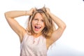 Young beautiful blonde woman holding both hands on her head, exposing her hair, screaming, opening her mouth, shooting Royalty Free Stock Photo