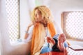 Young beautiful blonde woman relaxing at home - focus on feet and defocused face - concept of relax and lifestyle - coloured and Royalty Free Stock Photo