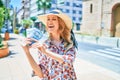 Young beautiful blonde woman on vacation wearing summer hat smiling happy Royalty Free Stock Photo