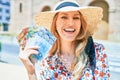 Young beautiful blonde woman on vacation wearing summer hat smiling happy Royalty Free Stock Photo