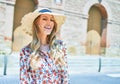 Young beautiful blonde woman on vacation wearing summer hat smiling happy Royalty Free Stock Photo