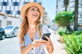 Young beautiful blonde woman on vacation wearing summer hat smiling happy Royalty Free Stock Photo