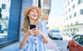 Young beautiful blonde woman on vacation wearing summer hat smiling happy Royalty Free Stock Photo