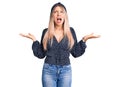 Young beautiful blonde woman wearing casual clothes crazy and mad shouting and yelling with aggressive expression and arms raised Royalty Free Stock Photo