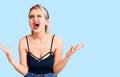 Young beautiful blonde woman wearing casual clothes crazy and mad shouting and yelling with aggressive expression and arms raised Royalty Free Stock Photo