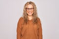 Young beautiful blonde woman wearing casual sweater and glasses over white background with a happy and cool smile on face Royalty Free Stock Photo