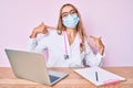 Young beautiful blonde woman wearing doctor uniform and medical mask looking confident with smile on face, pointing oneself with Royalty Free Stock Photo