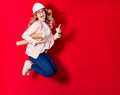 Young beautiful blonde woman wearing glasses holding architect hardhat smiling happy Royalty Free Stock Photo