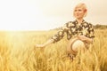 Young beautiful blonde woman in wheat field. Hand of young woman touching spikelets cereal field. Agriculture harvest, food Royalty Free Stock Photo